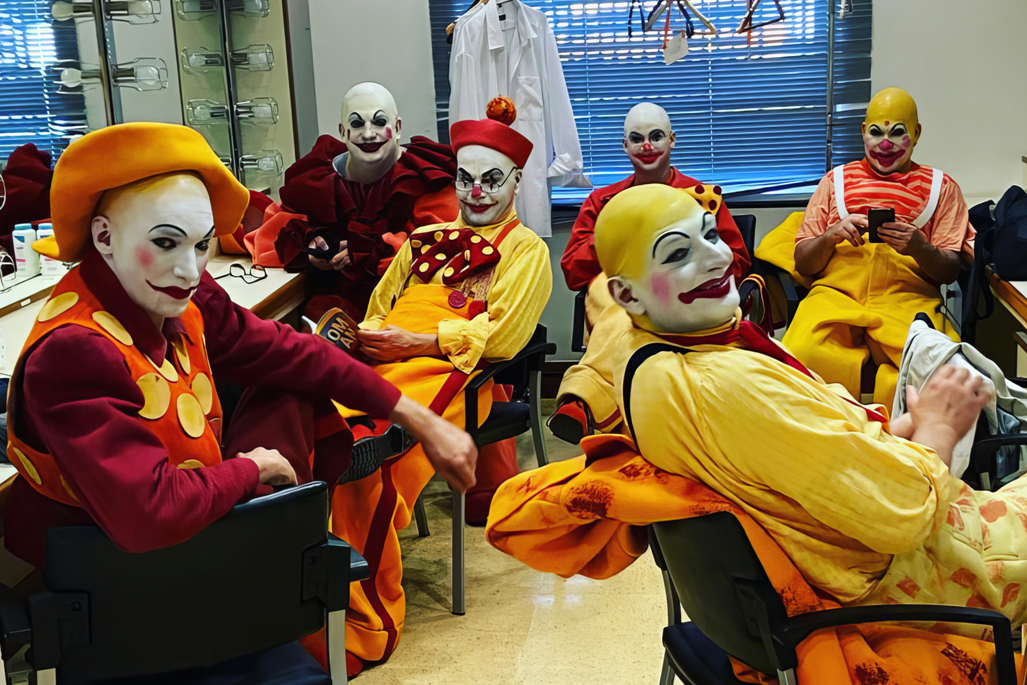 Performers costumed as clowns in red and yellow