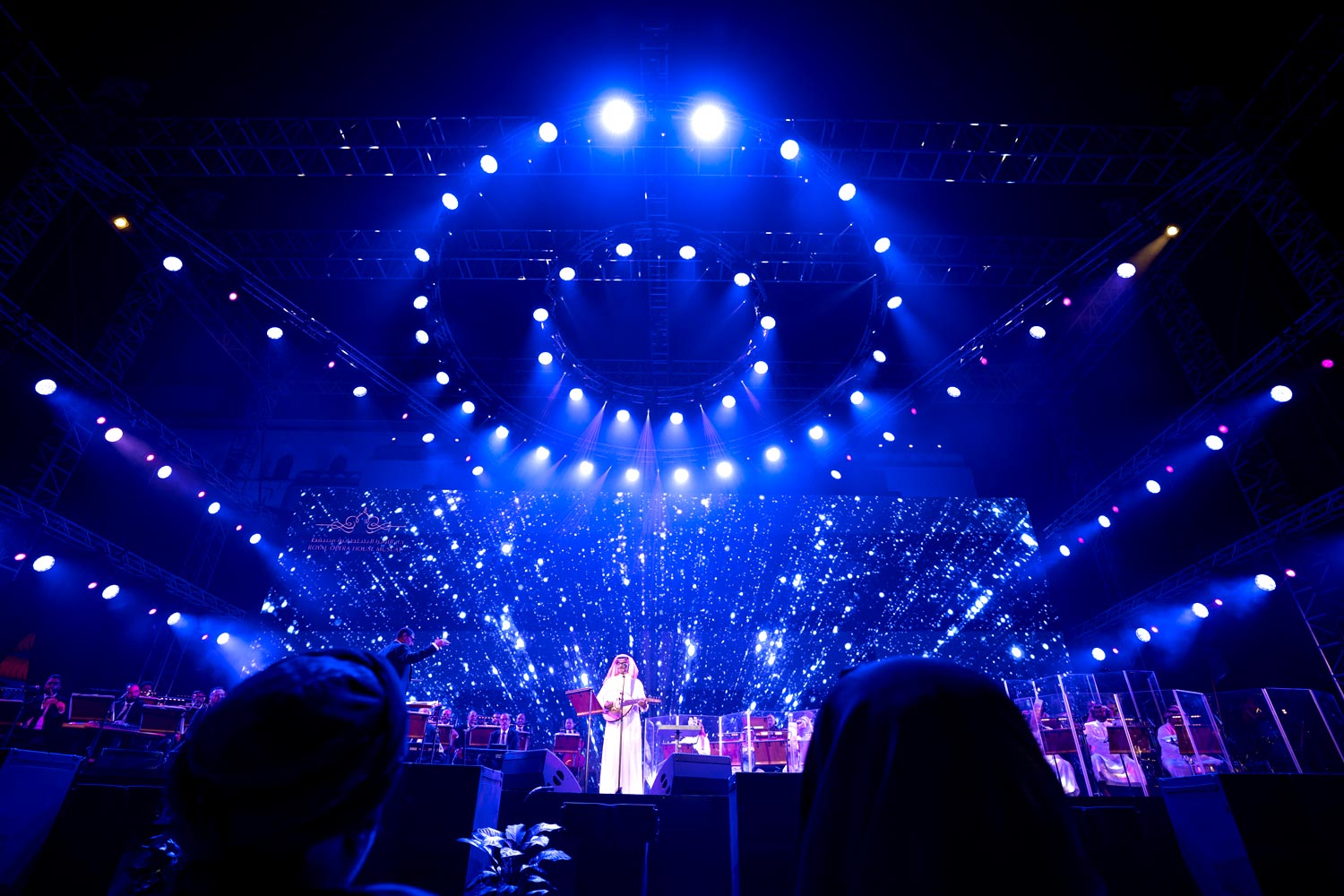 Outdoor concert with full lighting rig and orchestra