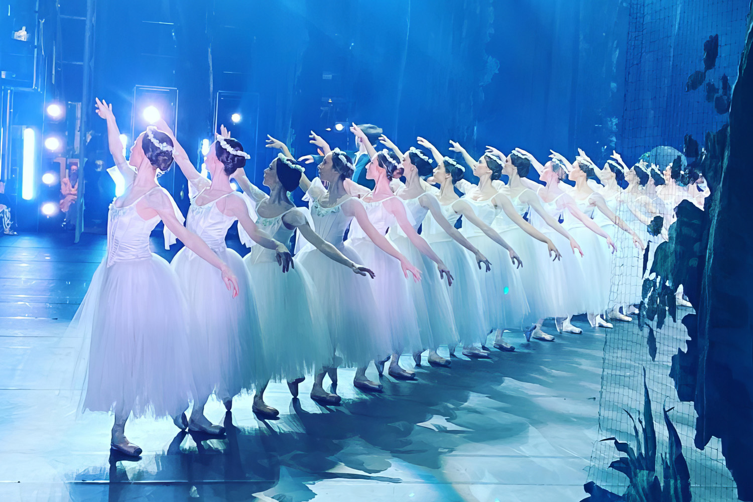 Corps de ballet dancers in white tutus on stage