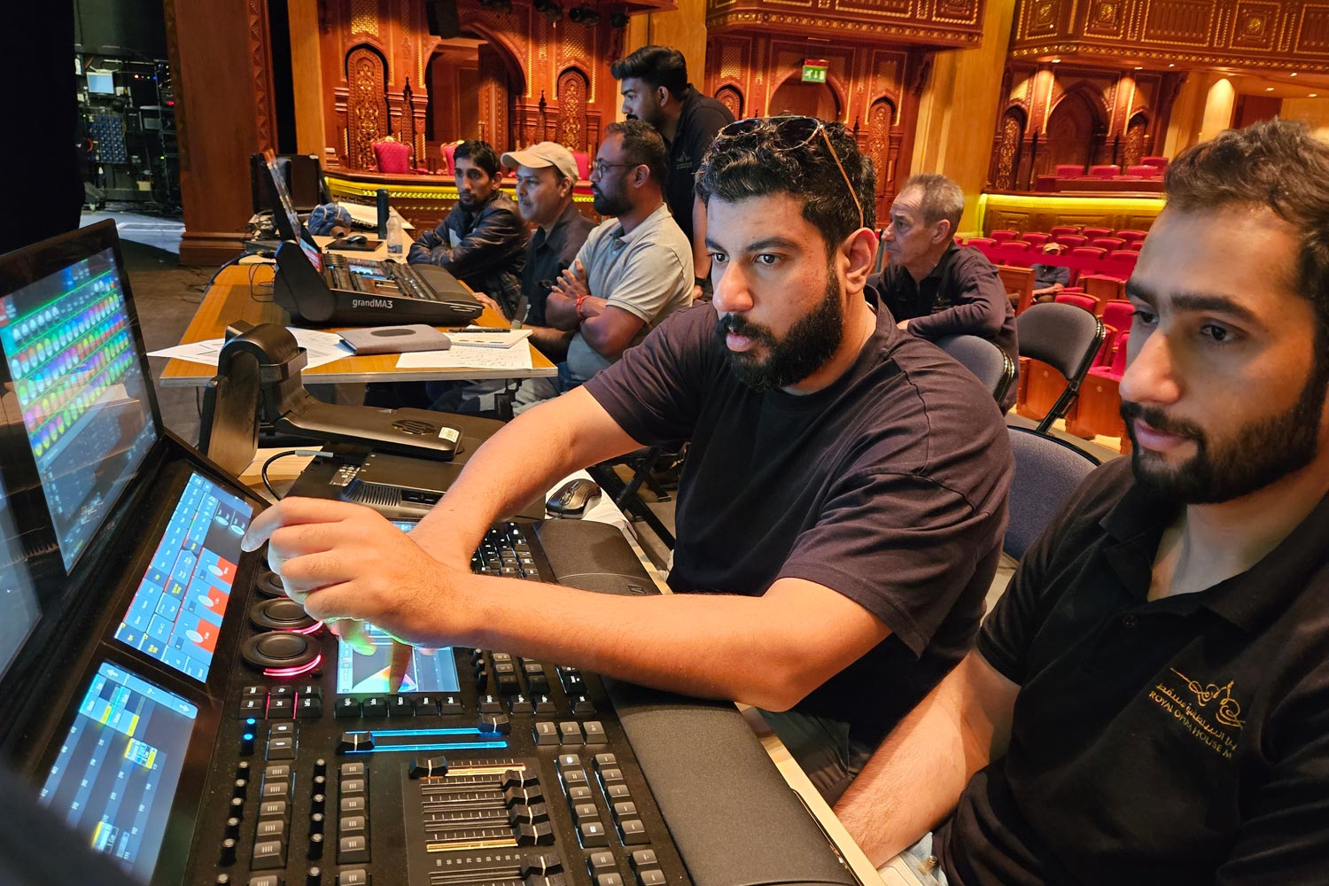 Lighting team programming the show at the grandMA3 console