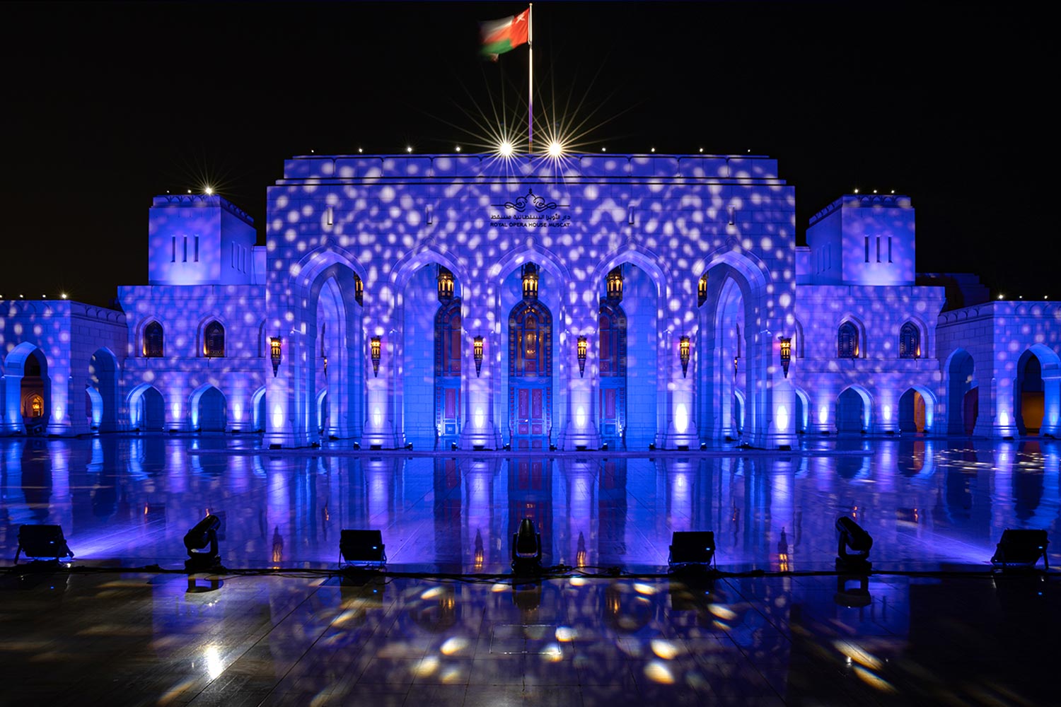 Royal Opera House Muscat exterior lit blue at night